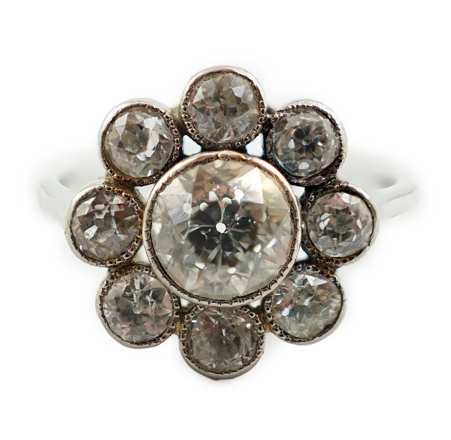 A platinum? and millegrain set nine stone diamond flower head cluster ring